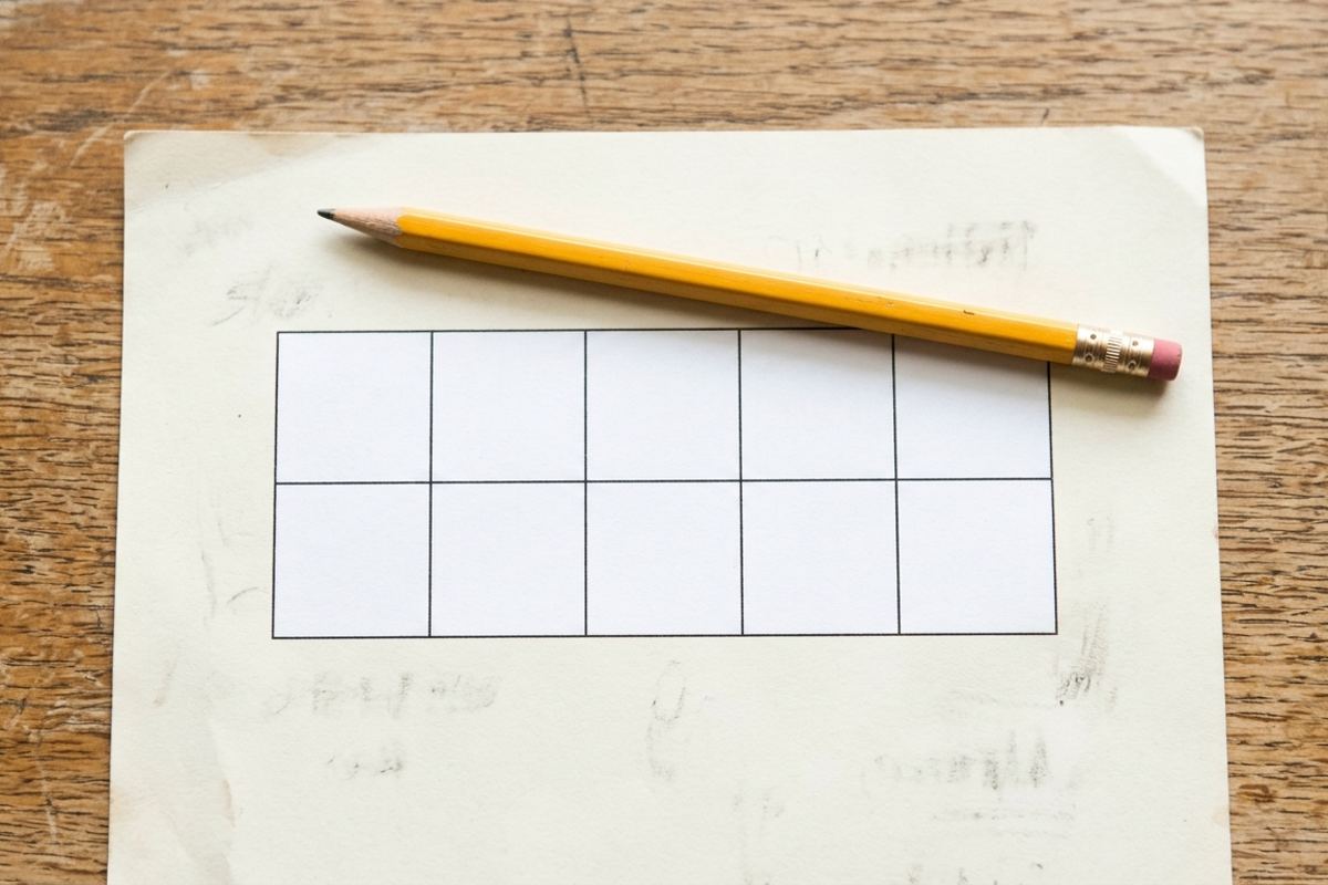 Math worksheet with an empty ten-frame grid and a pencil on a table