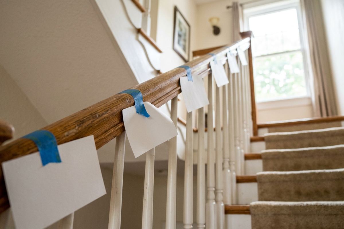 Blank index cards taped along a staircase railing for word practice